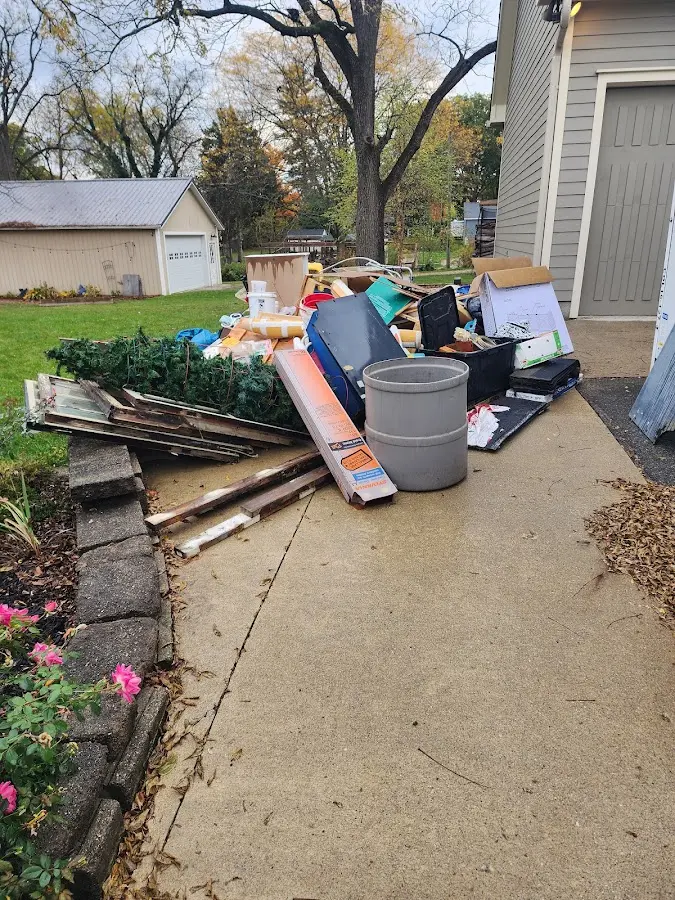 Dumpster being loaded with debris for Commercial Dumpster Rental in Woodbury